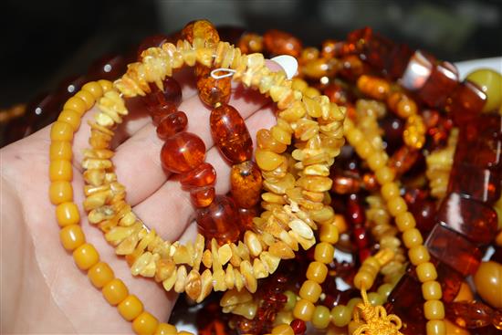 A quantity of amber and faux amber bead necklaces.